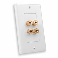 White Decora wall plate with four gold-plated speaker binding posts for audio system connections