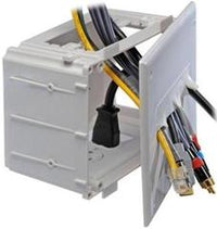 White recessed home theater media box with open door showing internal cable management compartments and organized wiring sto…