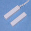 Two white 1 1/4 inch surface mount magnetic alarm contact switches with one featuring an attached white cable