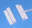 White 1 inch gap surface mount alarm magnetic sensor with tweezers on blue background