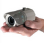 Compact weatherproof IR bullet camera with white housing held in palm, featuring adjustable lens and mounting bracket