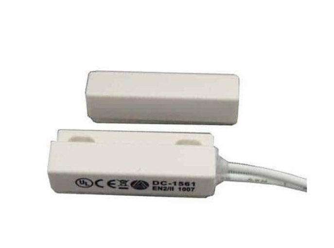 White magnetic contact sensor with 3/8 inch gap, press-fit design, showing cable attachment and certification markings Main image
