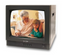 SecurityMan 14-inch CRT CCTV digital color monitor displaying video feed of grandmother and grandchild reading together