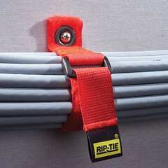 Red RIP-N-10-G10-BK CinchStrap cable management strap securing gray cables to white wall surface