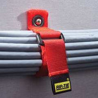 Red CinchStrap cable management strap with yellow RIP-TIE label securing gray cables to pipe