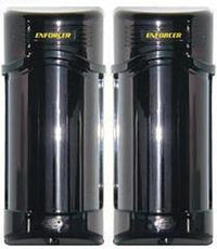 Twin outdoor photobeam detectors with black cylindrical housing and gold SECO-LARM branding for perimeter security