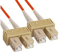 SC-SC duplex multimode fiber patch cable with orange connectors and beige coupling adapters, 10 meter length