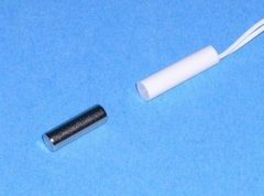 1/4 inch recessed magnetic alarm contact in white and black components on blue background Main image