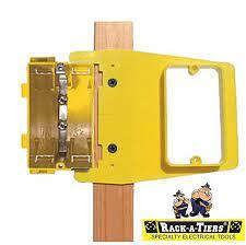 Yellow RAC-LJ50R Level Jack mud ring mounted on wooden pole with self-leveling mechanism and electrical box housing